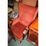 Mid 20th Century Parker Knoll style rocking armchair, upholstered in a buttoned back rust coloured