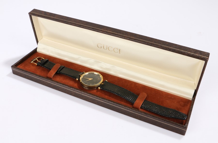 Gucci ladies gilt wristwatch, the signed black dial with gilt Roman numerals, quartz movement, the