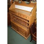 Pine side cabinet, the three quarter galleried top inset with animal decorated tiles above two