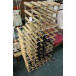 Three wine racks together with bottles of red wine