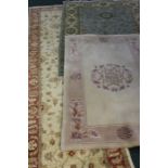 Two carpets and a runner, the carpets with cream grounds and foliate decoration, 154cm and 190cm