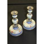 Pair of 19th Century white metal and enamel candlesticks, with beaded sconces above foliate enamel