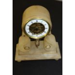 Edwardian swinging cherub mantle clock, the onyx clock with a white enamel chapter ring above arched