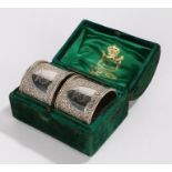 Pair of Victorian silver napkin rings, London 1877, maker Charles Edwards, the scroll decorated