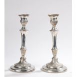 Pair of plated candlesticks, with swirled gadrooned sconces, gadrooned tapering stems and swirled