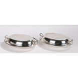 Pair of silver plated entree dishes, with beaten decoration and pierced carrying handles, 29cm