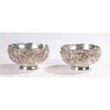 Pair of Chinese silver bowls, each cast with a dragon amongst foliage, each signed to the base, 13cm