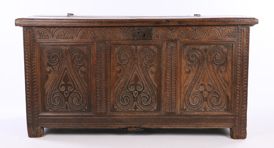 17th Century oak and elm coffer, the hinged rectangular top above an carved frieze and three