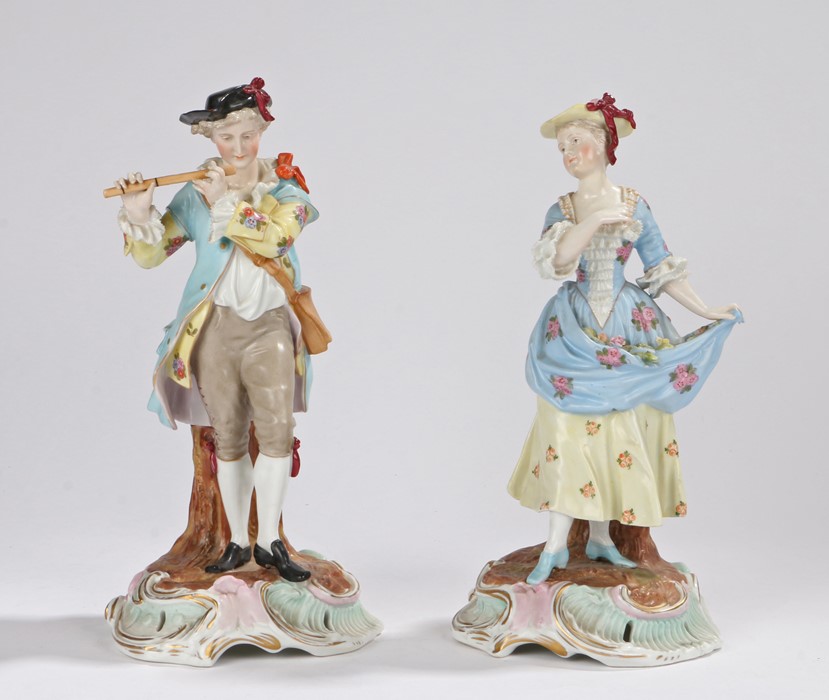 Pair of Sitzendorf porcelain figures, of a courting couple, the gentleman playing a flute and the