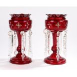 Pair of 19th century ruby glass candle lustres, with enamel foliate decoration to the bowls with