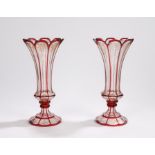Pair of 19th Century glass vases, with cranberry glass edges and gilt scrolling designs, 27cm