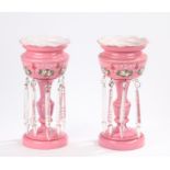 Pair of Victorian table lustres, in pink glass with foliate enamel decoration and clear glass drops,