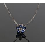 Sapphire and diamond set pendant necklace, in the form of a flower head, the central diamond with