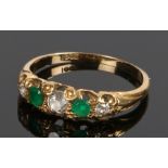 18 carat gold emerald and diamond set ring, with two emeralds and three diamonds to the head, ring