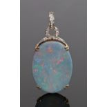 Opal and diamond set pendant, with an oval opal and a diamond set top arch and loop, 20mm diameter