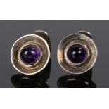 Pair of Bukor silver and amethyst cufflinks, with cabochon cut heads and dished circular frames,