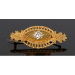 15 carat gold diamond set brooch, with nine diamonds forming a flower head central design, 45mm