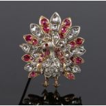 Diamond and ruby set peacock brooch, the peacock set with rubies and diamonds to the body and tail