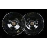 Pair of art glass dishes, each with a central bronze roundel depicting six figures, initialled
