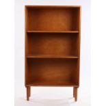 1970's teak open bookcase with two shelves, raised on turned tapering legs, 60cm widewater ring