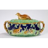 Majolica game pie dish by George Jones, the lid with a quail finial on a ground of ferns, the base