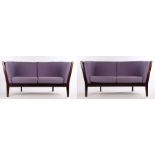 Pair of Stouby dark stained settees, with turned spindle backs and purple upholstered cushions,