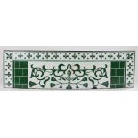 Enamel upstand, the green scroll decorated centre flanked by brick effect sections and a fleur de