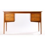 1970's teak desk, with four drawers to the frieze, raised on chamfered square legs, 127cm