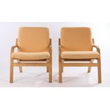 Pair of Stouby beech armchairs, with cream upholstered cushions, down-swept arms, raised on