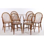 Four Ercol elbow chairs, with turned spindle backs and arm supports, solid dished seats, on turned