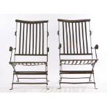 Pair of steel folding chairs, with an arched bar back above the slats and slatted seat on cross