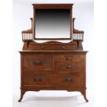 Art Nouveau oak dressing table, the bevelled mirror above two small drawers, the base with