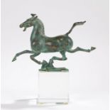 Spelter figure depicting a running horse, raised on a clear glass square plinth base, 21cm wide,