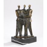 Bronze sculpture depicting three figures in an embrace, raised on a black and white marble base,