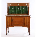 Arts and Crafts style oak washstand, the pierced heart pierced above a green and red mottled tile