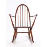 Ercol rocking chair, with turned spindle back and arms, solid dished seat, on turned legs and