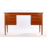 1970's teak desk, with arrangement of six frieze drawers, raised on turned tapering legs, 130cm