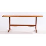 1970's teak coffee table, raised on silhouette supports and out-splayed legs united by a shaped