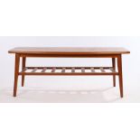 Mid 20th Century teak coffee table, the top with curved edge raised on turned legs united by a