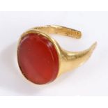 Gold coloured metal ring with amber effect head, band cut, 5.6g