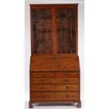 George III mahogany bureau bookcase, the astragal glazed bookcase top above a sloping fall enclosing