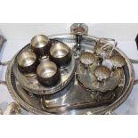 Collection of silver plated items, to include a cruet stand, trays, tulip vase, four cups and an egg
