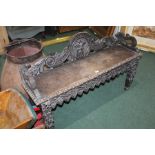Oak hall bench, with mask and scroll carved back, on silhouette carved legs