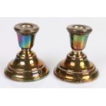 Pair of George VI squat silver candlesticks, on loaded stepped bases, 7.5cm high