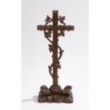 Carved oak cross, with vine decoration on a rocky outcrop base, 36.5cm highCross has been broken and