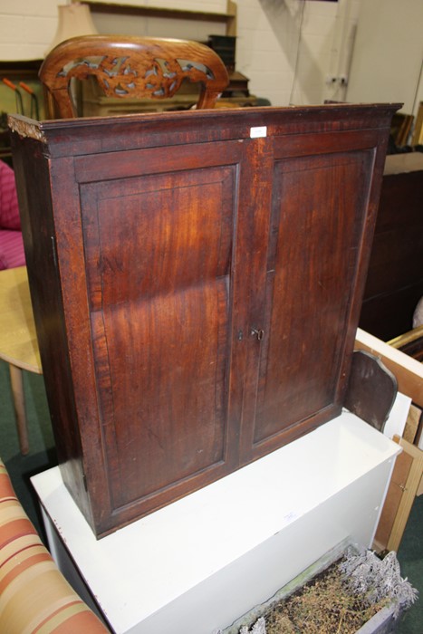 Mahogany cupboard, with paneled doors opening to reveal three adjustable interior shelves