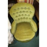 Edwardian armchair, in green fabric with a bow fronted seat flanked by arms upon turned legs
