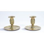 Pair of early 18th Century brass candle sconces, with reeded stems and dished bases, 10cm high, 13.