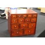 Indonesian hardwood miniature chest of fourteen graduated drawers, 37.5cm wide