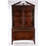 George III style mahogany bookcase cabinet, the arched pediment with fret decoration above fret